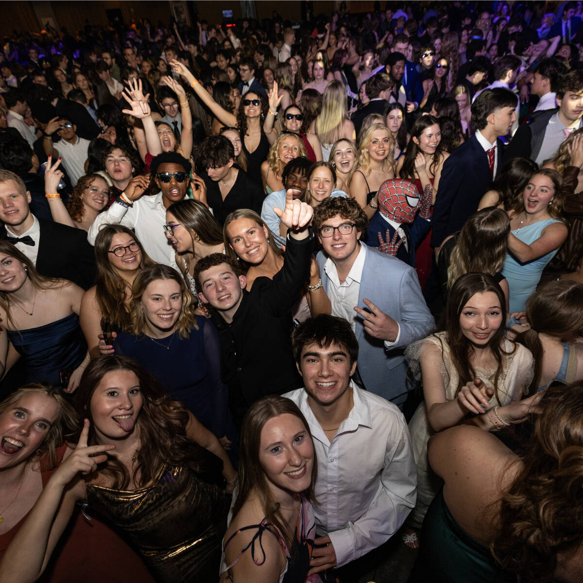 A crowd of formally-dressed students dancing at Presidents' Ball